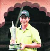 Liang Wen-Chong of China poses with the winners trophy.