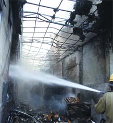 Firefighters try to douse the fire at Wazirpur in New Delhi