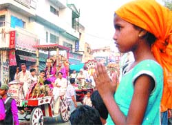 Devotees take out a shobha yatra on the eve of Maharishi Valmiki Jayanti in Jalandhar on Monday