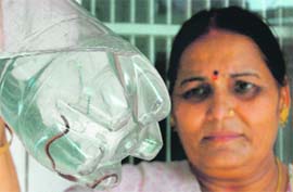 Chander Lata Verma of Jammus Nanak Nagar shows the snake that came out from a water tap in her house.