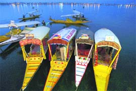 Tourists enjoy a boat ride in Dal Lake in Srinagar on Monday.