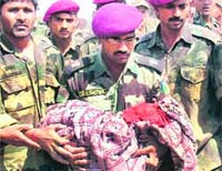 Army personnel carry the body of Sonu, who fell into a borewell four days ago, at village Lehrapur in Agra on Monday.