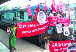 CPI (M-L) activists block a train at Bhubaneswar on Monday in protest against the communal violence in Kandhamal
