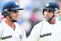 Ganguly (L) and Laxman return to the dressing room after play was suspended due to bad light. India, set a victory target of 299 runs in 83 overs on the last day, were 177 for four when bad light forced the umpires to call off play. 