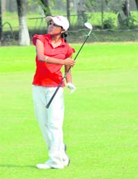 Preetinder Kaur watches the ball after a big hit on the 18th in the fourth leg of the DLF Women's Professional Golf Tour at the Chandigarh Golf Club