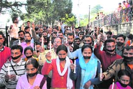 A candlelight march by PTA teachers in protest against the government in Shimla on Tuesday. 