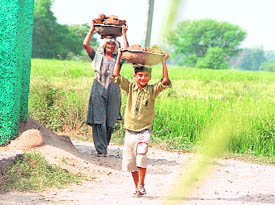 This child seems happy sharing the burden of an elderly kin near Jammu.