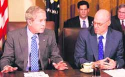 US Secretary of Treasury Henry Paulson (R) listens to US President George W. Bush at a cabinet meeting to discuss the economy in the Cabinet Room at the White House in Washington 