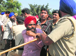 The police takes the visually impaired to custody outside the Punjab and Haryana Civil Secretariat in Chandigarh on Wednesday.