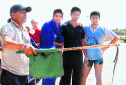A snake being taken out of a boat at Sukhna Lake, Chandigarh, on Wednesday. 