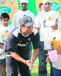 Master blaster Sachin Tendulkar washes his hands on the occasion of World Handwash Day at the PCA Stadium in Mohali on Wednesday.