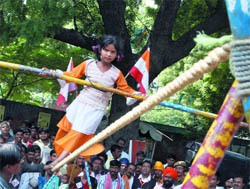 Six-and-a-half-year-old Roopa belonging to a nomadic Banjar community at Jangir in Chhattisgarh exhibits her acrobatic skills during a rally at Jantar Mantar 