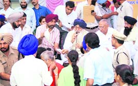 Chief Minister Parkash Singh Badal listens to problems of people during a sangat darshan in Ludhiana on Wednesday. 