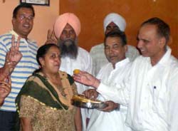 Devinders family member being offered sweets in Barnala on Wednesday. A Tribune photograph