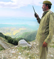 A police officer standing at take-off point of the Himalayan paragliding contest waiting for weather to clear at Bir-Billing (Dharamsala) on Thursday.