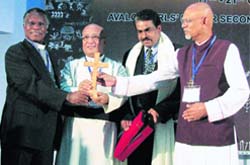 Chief guest Samuel Kobia, general secretary, World Council of Churches, Geneva, presents a cross to moderator Rev V. Mal at the 13th edition of ordinary synod of the Church of North India in Pathankot