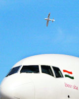 A 'Sportsstar' two-seater aircraft flies over an Air India Boeing 777 on the final day of the India Aviation 2008 show at Begumpet Airport in Hyderabad on Saturday.