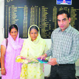 Deputy commissioner Kangra K.K. Pant gives award to the sarpanch of Simbal Khola village for achieving total sanitation.