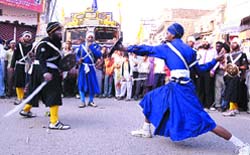 Sikh devotees perform gatka during a nagar kirtan organised as part of the tercentenary celebrations of Gurta Gaddi Divas of Guru Granth Sahib in Jalandhar 