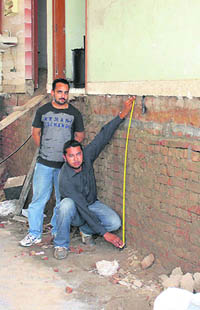 Amar Singh from Nurpur Bet village, near Ludhiana, shows the height his house has gained after it was raised using jacks