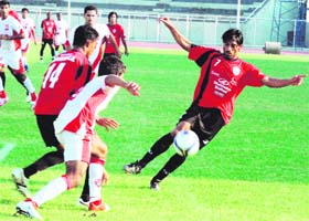 Mahindra United's Sushant Mathew (R) and JCT's Balwant Singh fight for the ball during their I-League match at the Guru Nanak stadium in Ludhiana
