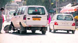 A damaged vehicle parked right in the middle of road in Kangra town which led to traffic problem. 