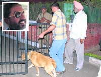 Members of the dog squad enter the Sector-39 house of IAS officer A.S. Chhatwal (inset) in Chandigarh on Monday. 