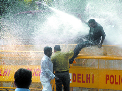 Police uses water cannon to disperse members of the youth wing of the BJP protesting against Amar Singh and recent attacks on journalists in New Delhi on Monday.