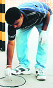 A forensic official collects evidence from a crime spot.