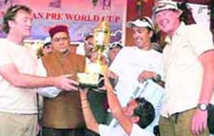 Chief Minister Prem Kumar Dhumal gives away the trophy to the overall champion of the Pre-World Cup Paragliding Championship at Bir-Billing on Monday.