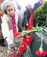 A woman places flowers at the "Yama" memorial in the centre of Minsk on Monday. Belarus marks the 65th anniversary of the destroying of Minsk's ghetto during World War II, when several hundred thousand Jews were slaughtered.