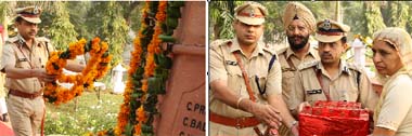 DIG Faridkot range Jitendra Jain laying a wreath at the memorial to pay homage to policemen who achieved martyrdom in the line of duty at the Police Lines in Bathinda on Tuesday; SSP Asish Chaudhary, SP (H) Harbhajan Singh and the DIG honouring the family member of a martyr