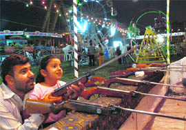 A girl with her father at a Diwali mela at Sector 34 in Chandigarh on Tuesday.