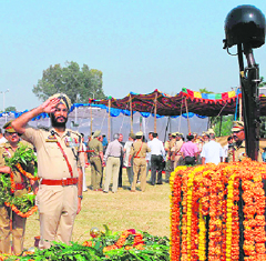 Officers queue up to pay homage to police martyrs at Police Ground in Jammu on Tuesday.