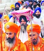 The head granthi, Darbar Sahib, carries the holy scripture before the start of the nagar kirtan from Akal Takht in Amritsar