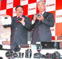 President and CEO of Canon India Kensaku Konishi (R) and the company's senior vice-president Alok Bhardwaj pose with Canon products in New Delhi on Wednesday. Canon launched 85 digital imaging products, including digital cameras, video camcoders, printers, all-in-ones, digital copiers. 