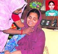 The mother of deceased Navjot Kaur (inset) being consoled by a relative. 