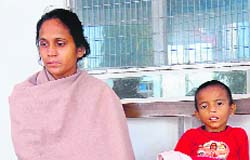 Haseena Bano along with her seven-year-old son at Kotwali police station in Dehradun. 