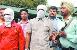 The Delhi police presents two persons involved in carjacking and robbing ATM cards, cash and valuables in New Delhi 