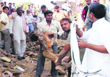 People carry the body of a girl killed in explosions in an illegal fireworks factory in Deeng town of Rajasthan on Thursday.
