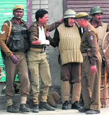 Police personnel assist a colleague injured in stone-pelting during an election boycott rally in Srinagar on Friday.