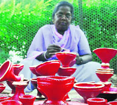 A potter gives finishing touches to earthen-lamps for Diwali in Sector-20, Chandigarh on Saturday.