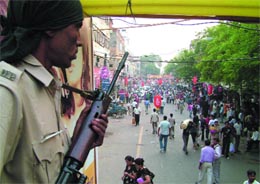 Hawks Eye: A Delhi police officer keeps a vigil on the Karol Bagh market bustling with Divali shoppers on Saturday.
