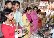 With only days left for Diwali, the festival of lights, residents of Bathinda throng the Dhobi Bazaar to make purchase on Sunday; and (right) City residents buying utensils on Dhanteras, celebrated on Sunday.
