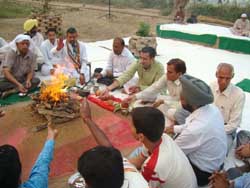 District collector Bhawani Singh Detha along with others performs rituals near the Bikaner Canal in Sriganganagar 