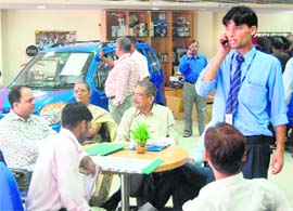 Prospective buyers turn up in large numbers at a car showroom in Dehradun on Sunday.