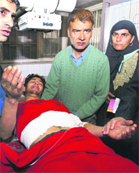 Relatives attend to a kin injured in Baramulla police firing in a Srinagar hospital on Sunday. 