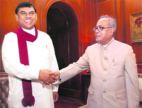 External affairs minister Pranab Mukherjee with Sri Lankan Presidents senior adviser and brother Basil Rajapaksa during a meeting in New Delhi on Sunday.