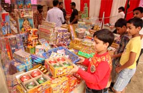 A child looks at the crackers on display at a market in Bathinda