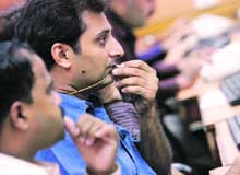 A stockbroker reacts while trading at a brokerage firm in Mumbai on Monday.